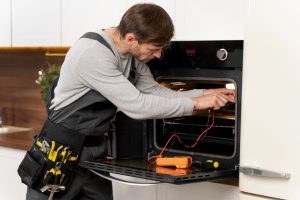 a man is repairing appliance